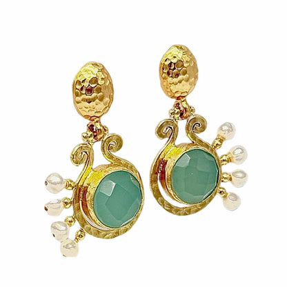 elegant handmade 21k gold plated recycled brass dangle earrings with aqua chalcedony center and pearl detailing On white backdrop