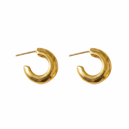 Handmade gold-plated Huggies on white background