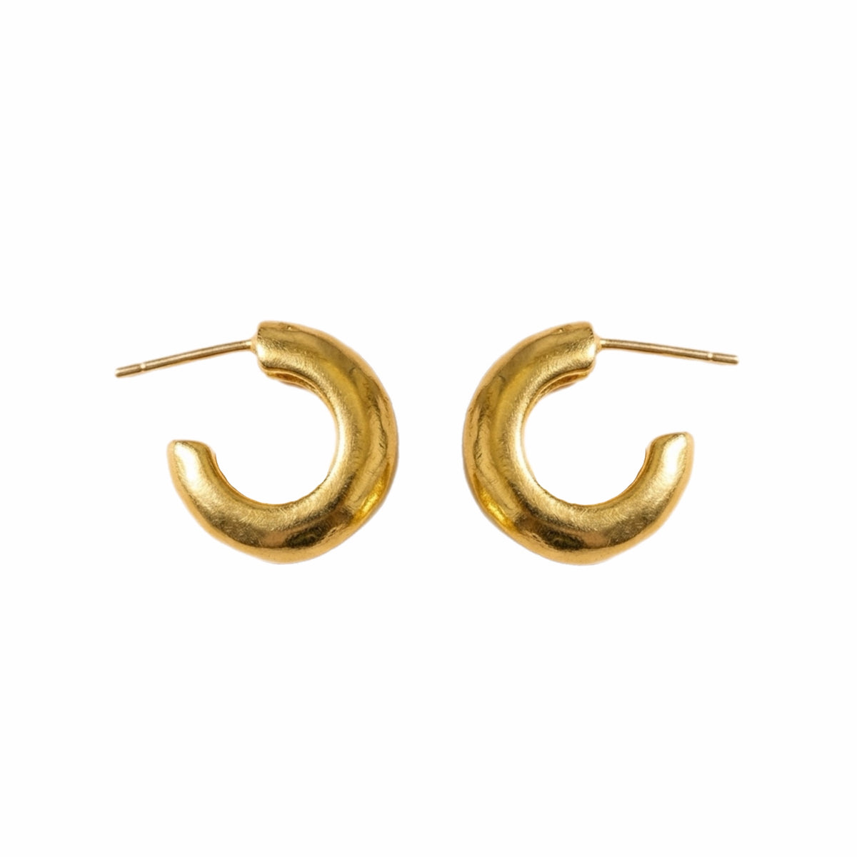 Handmade gold-plated Huggies on white background Side by side 