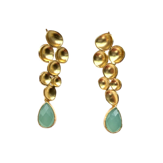 A pair of handmade gold drop earrings featuring a geometric design and a faceted aqua chalcedony teardrop gemstone at the bottom, set against a plain white background.