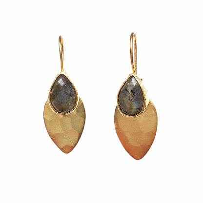 A pair of gold drop earrings with teardrop-shaped labradorite gemstone at the top and a larger hammered gold leaf-shaped drop