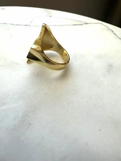 Handmade Gold-plated moon and star ring on a white marble surface