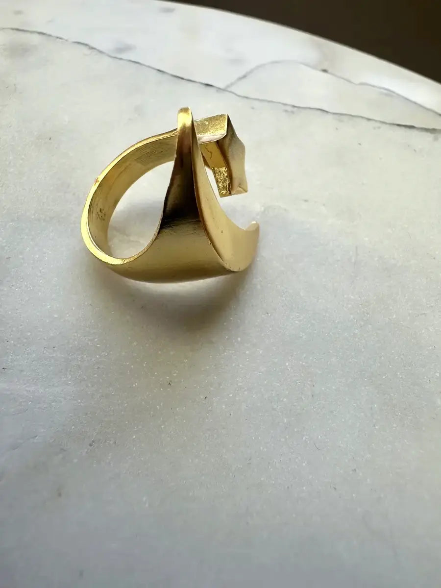 Handcrafted gold-plated moon and star ring on a marble surface