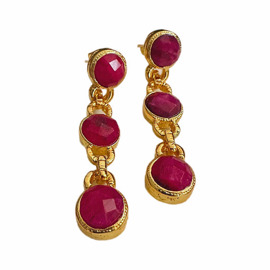 Handmade gold-plated multi-stone ruby and chain dangle earrings on white background 