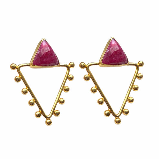 Handmade gold-plated triangle earrings with gold accents balls and faceted triangle ruby on white surface 