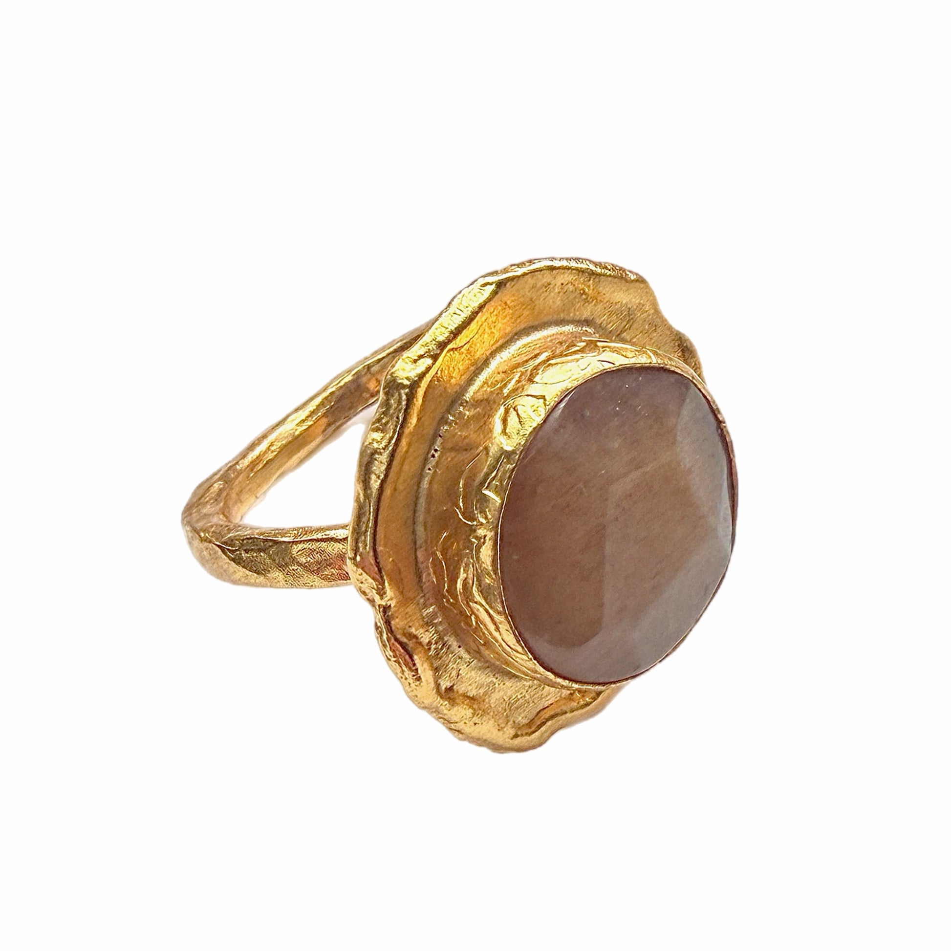 A handmade gold-plated cocktail gemstone ring with an orange quartz stone, shown on a plain white background in side angle