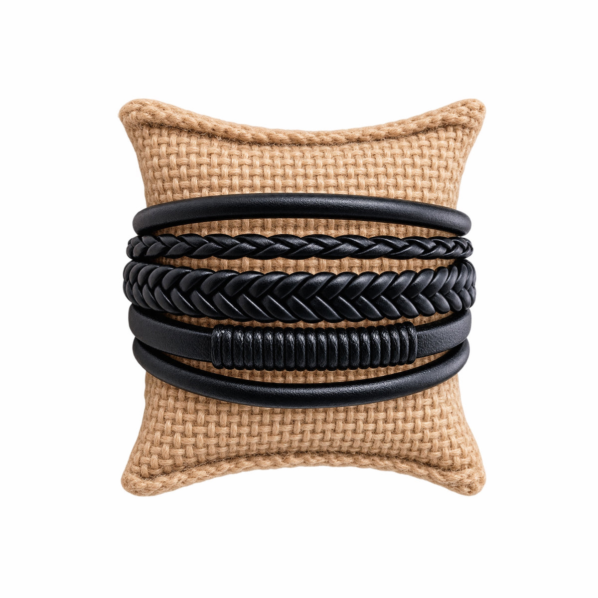 Handmade men’s rugged boho multi-strand braided black leather cuff bracelet on a tan jute jewelry pillow 