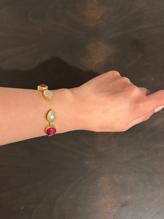 Hand wearing a gold-played ring and snow Quartz bracelet 
