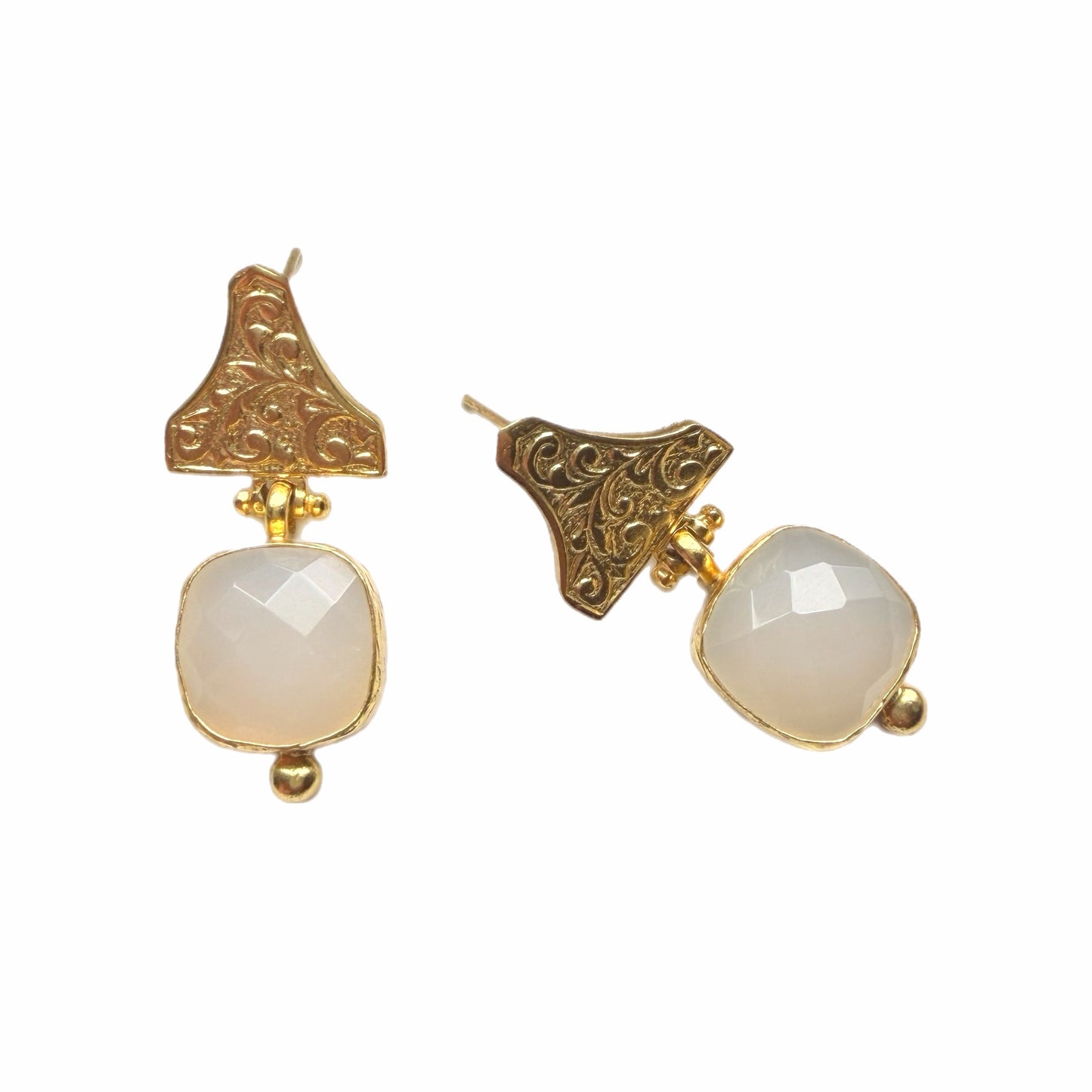 Handmade sustainable gold-plated faceted snow Quartz and Etruscan design drop earrings against white backdrop