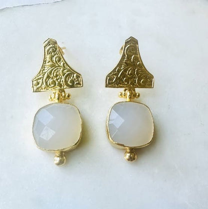 Handmade sustainable gold-plated faceted snow Quartz and Etruscan design drop earrings against white background 