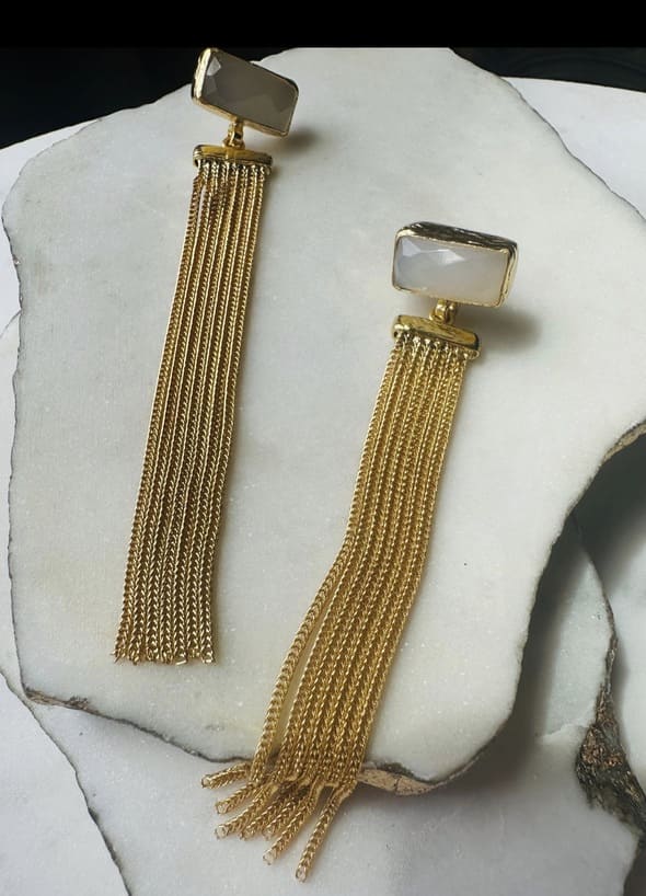 Artisanal eco-friendly Gold-plated long fringe earrings with snow Quartz on a white marble surface