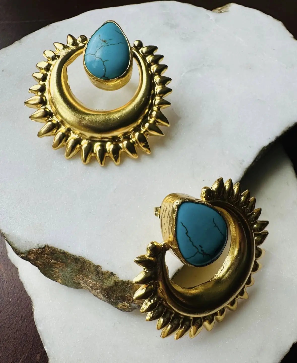 Bold artisanal sustainable Gold-plated turquoise stud earrings on a white stone surface
