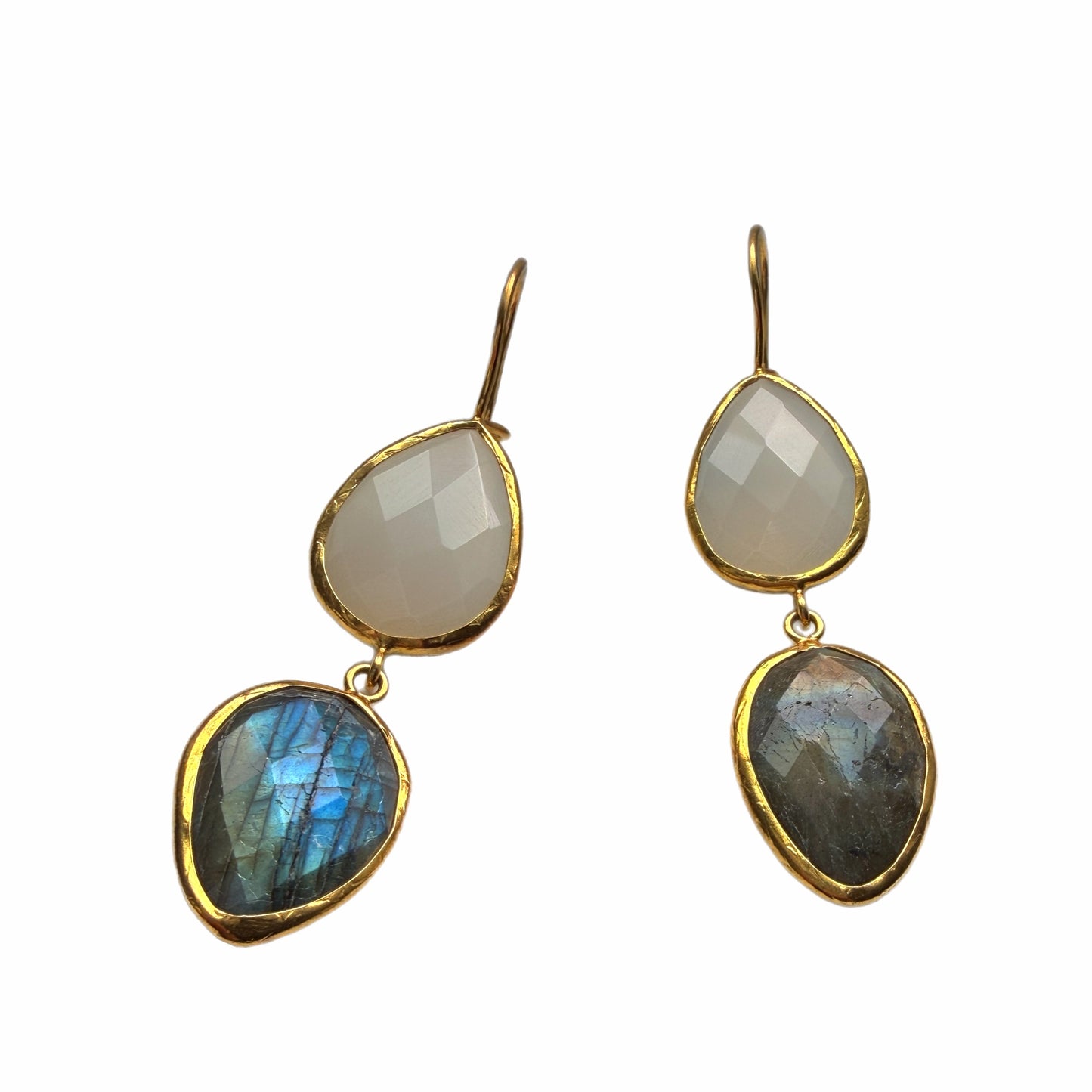 Handmade sustainable Gold-plated teardrop labradorite and snow Quartz dangle earrings placed on a marble surface