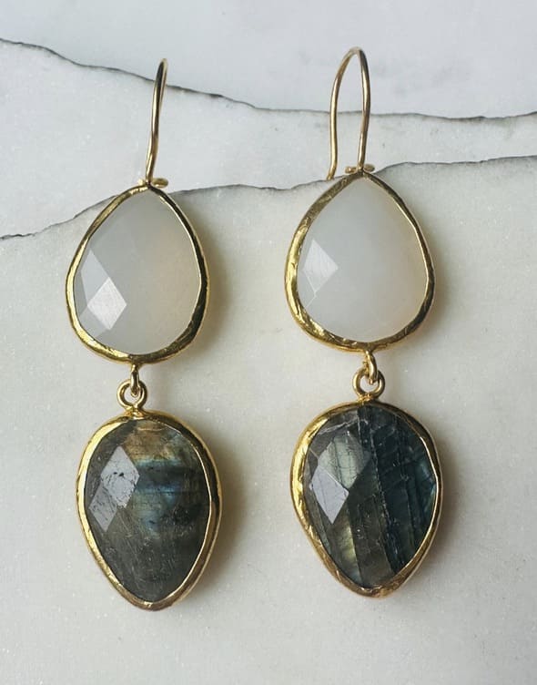 Handmade sustainable Gold-plated teardrop labradorite and snow Quartz dangle earrings with on a marble surface