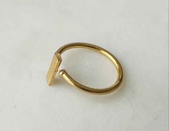 Handmade sustainable minimal Gold-plated waterproof ring with rectangle on a light gray background