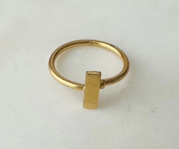 Handmade sustainable Gold-plated minimal ring with a rectangular tag on a white background