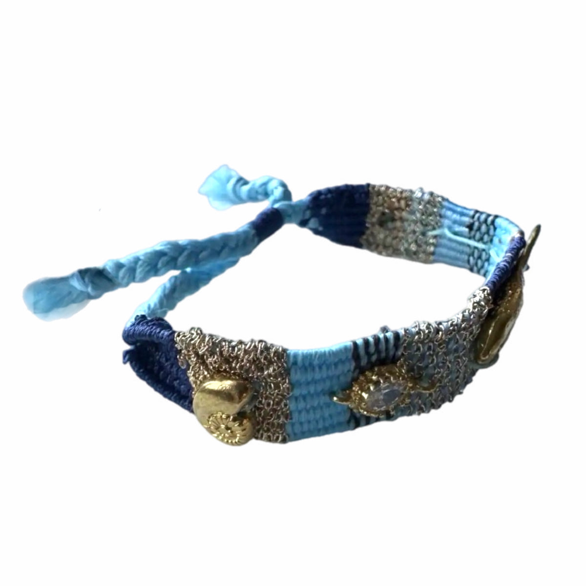 Turquoise, Blue and gold woven bracelet with gold plated fish charms, crystals, and beach resort charms on white surface