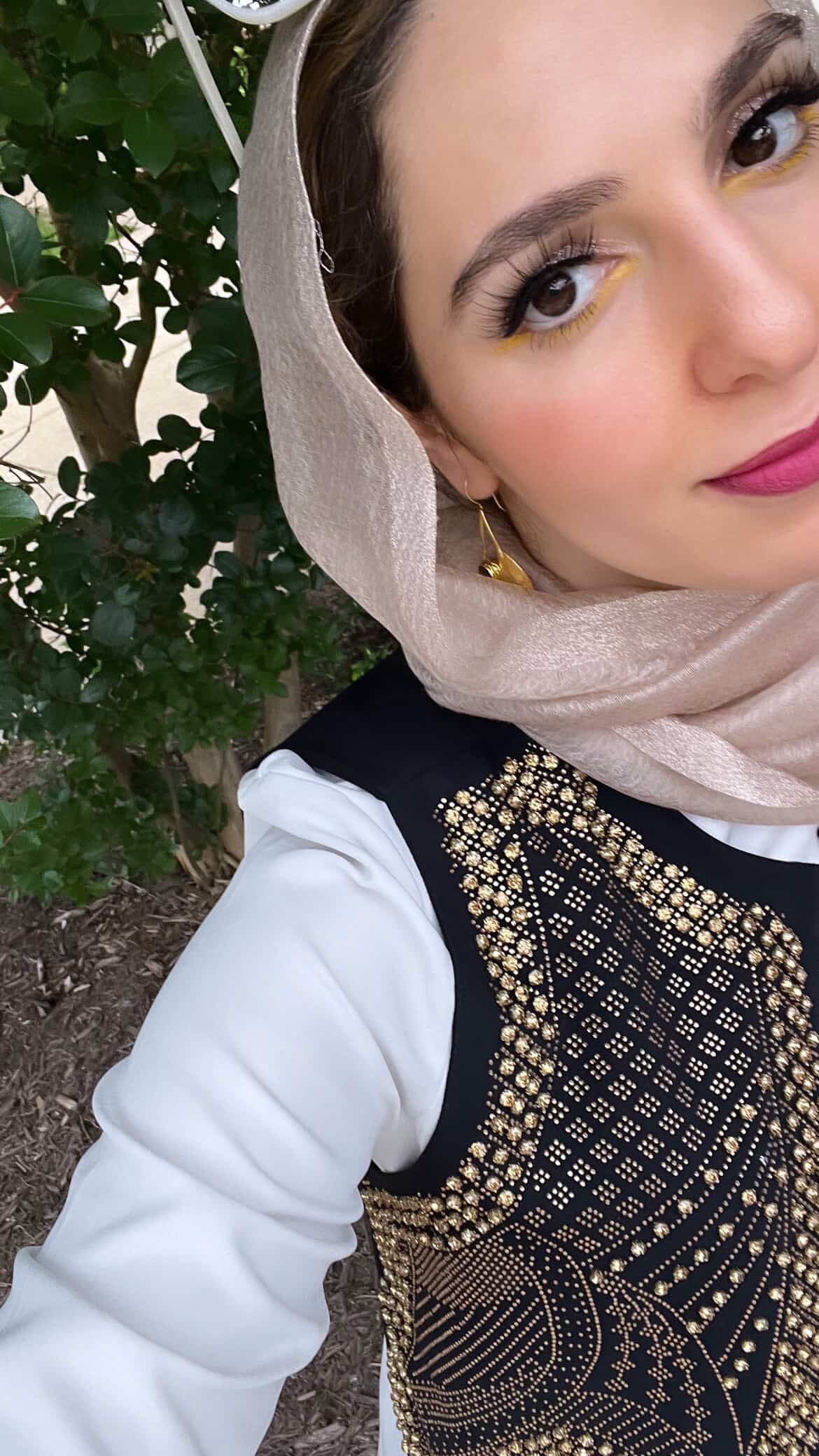 Muslim matchmaker Yasmin Elhady wearing a hijab an gold-plated sustainable Ruby statement earrings 