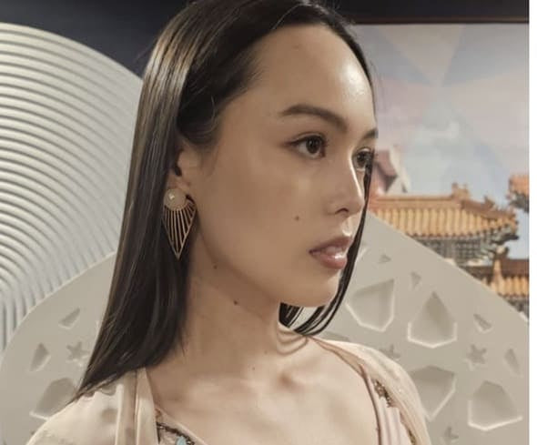 Asian American model wearing pink kaftan and artisan eco-friendly gold-plated rose quartz statement earrings 