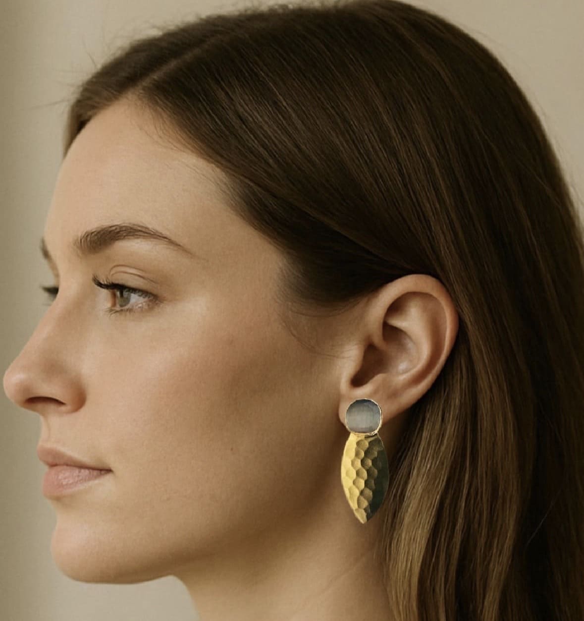 Woman wearing artisanal sustainable gold-plated gray gemstone earrings 