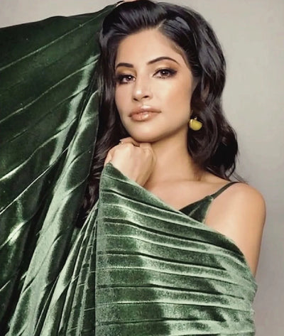 India American actor Richa Moorjani wearing green velvet dress and yellow agate and gold earrings by Bebek Jewels