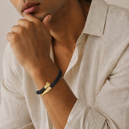 Man in banana republic beige linen button up collared shirt in natural light wearing a black woven gold nail design bracelet