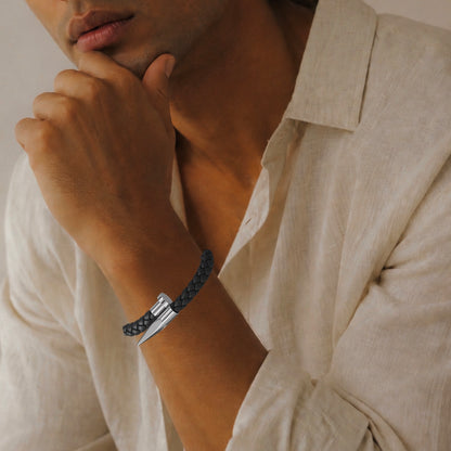 Man in banana republic beige linen button up collared shirt in natural light wearing a black woven silver nail design bracelet 
