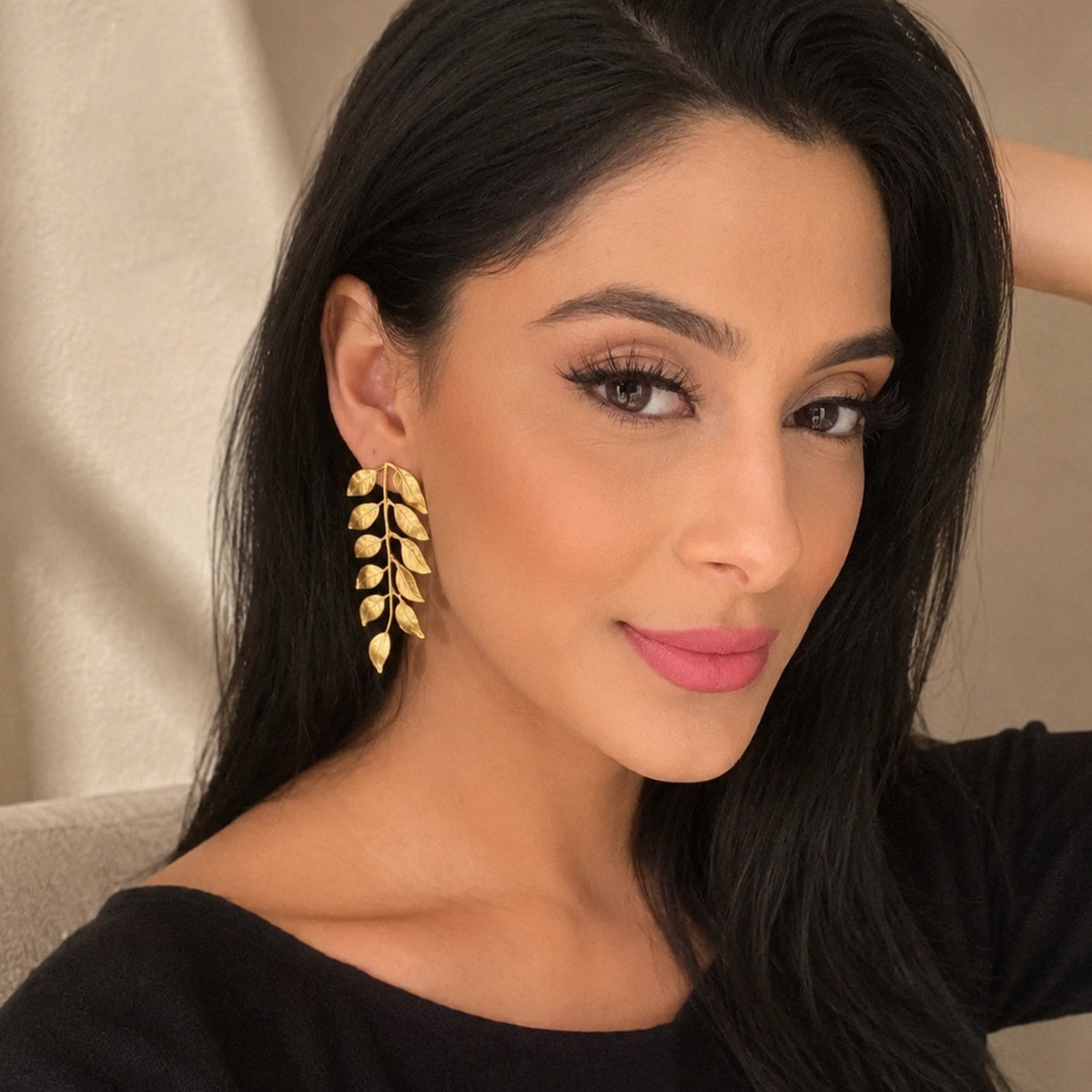 Manpreet Toor wearing gold plated vine earrings by Bebek Jewels with neutral background