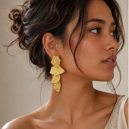 Model in Off shoulder beige top and messy bun wearing gold plated geometric dangle earrings