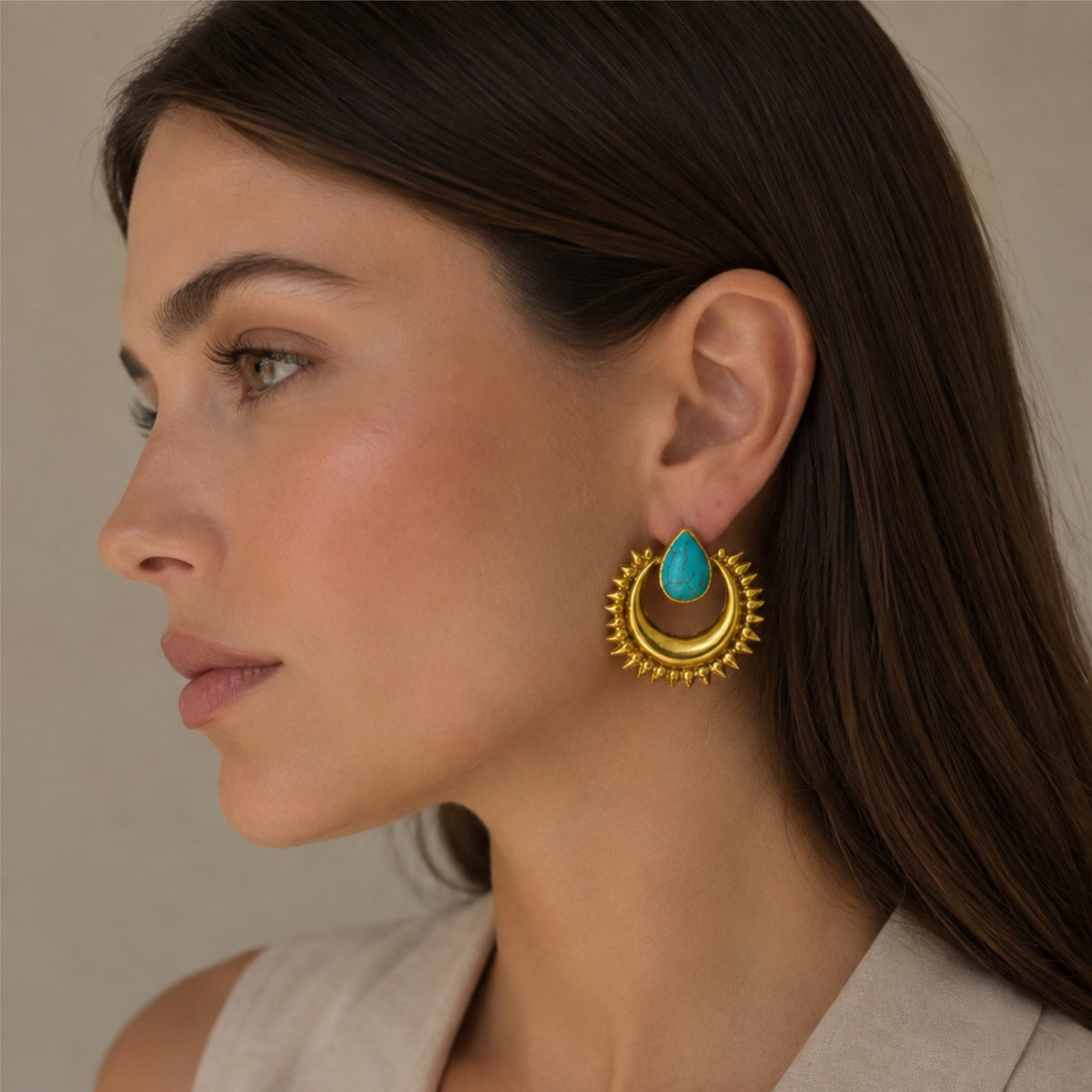 Model wearing beige aritzia top and gold plated sunburst turquoise earrings