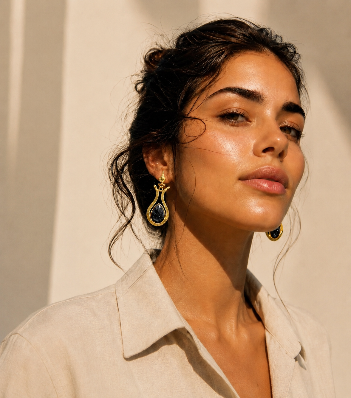 Woman in Aritzia blouse wearing handmade gold-plated lapis lazuli drop earrings 