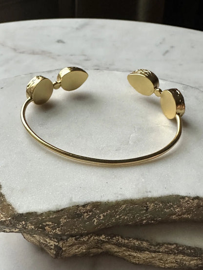 Small batch Gold-plated gemstone bracelet on a marble surface 