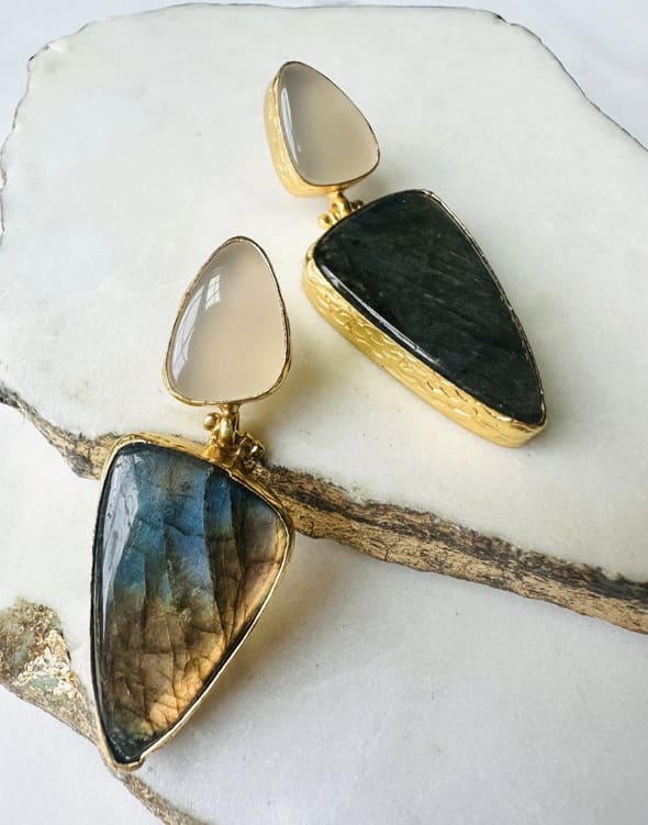 Handmade contemporary Gold-plated snow Quartz and green earrings on a white stone surface