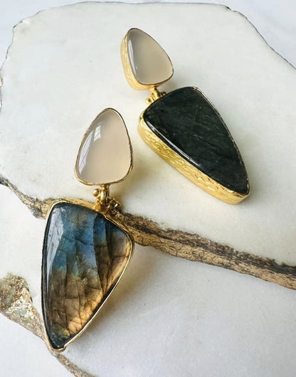 Handmade contemporary Gold-plated snow Quartz and green earrings on a white stone surface