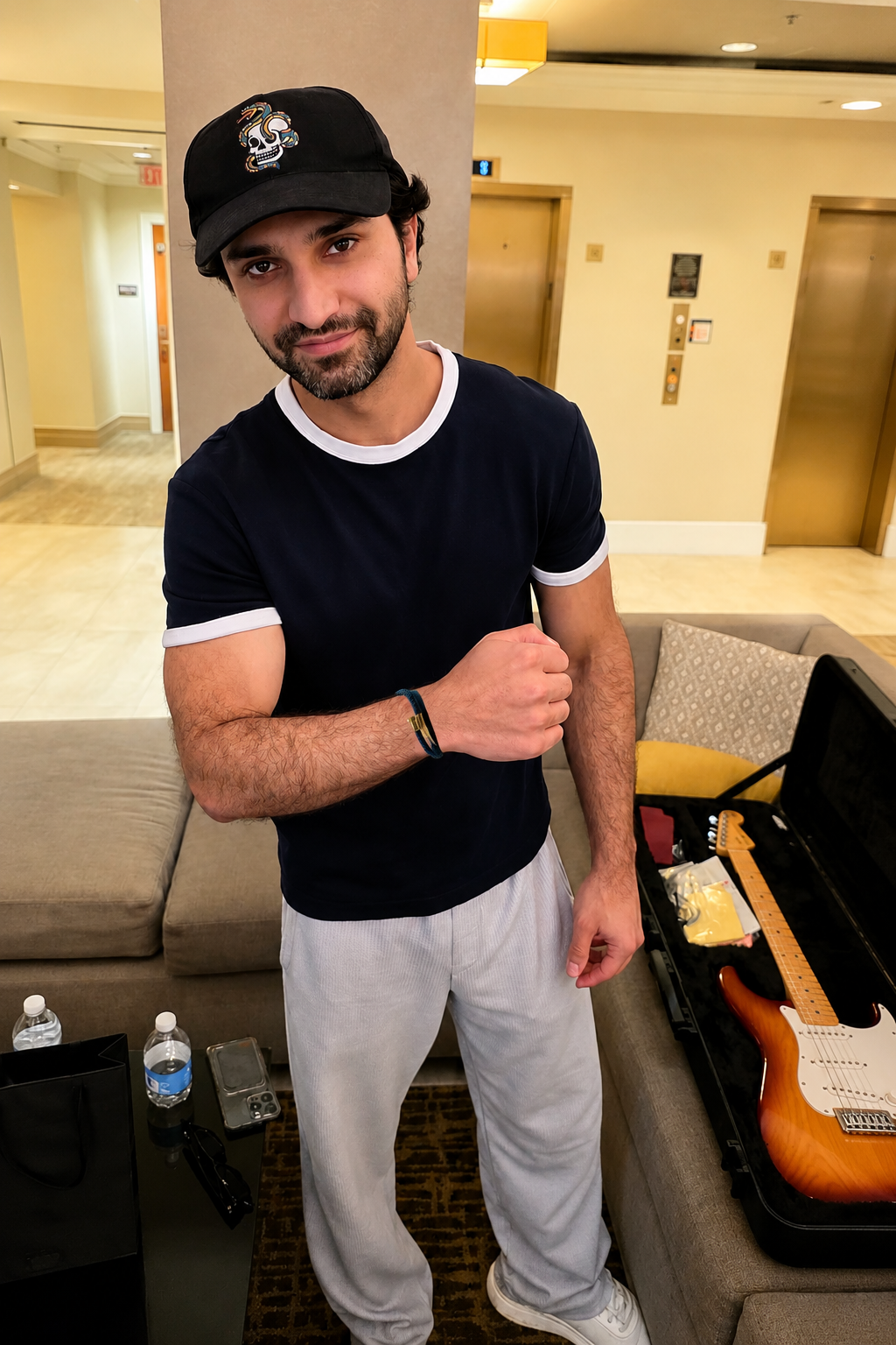 Ahad Raza Amir wearing leather woven bracelet by Bebek Jewels in hotel room 