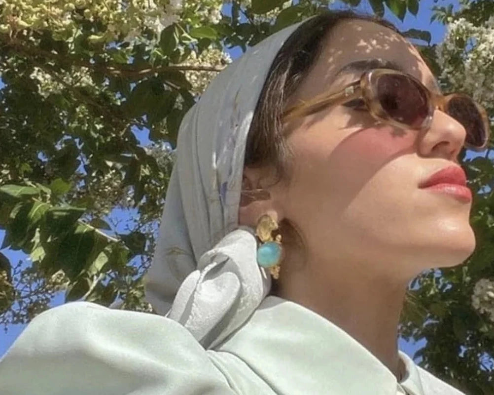 Palestinian American influencer Sally Ashour wearing turquoise and gold earrings by Bebek Jewels 