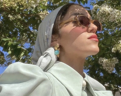 Palestinian American influencer Sally Ashour wearing turquoise and gold earrings by Bebek Jewels 