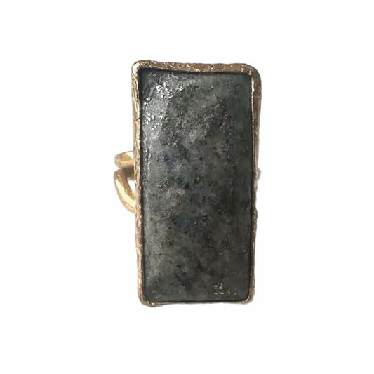 Rectangular gold-plated waterproof gray lapis lazuli cocktail ring on a white surface