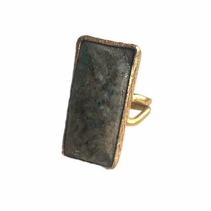 Rectangular gold-plated waterproof gray lapis lazuli cocktail ring on a white backdrop 