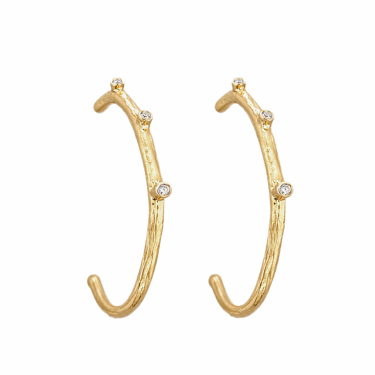 Texture finished gold-plated contemporary hoop earrings with cubic zircon accents On white background 