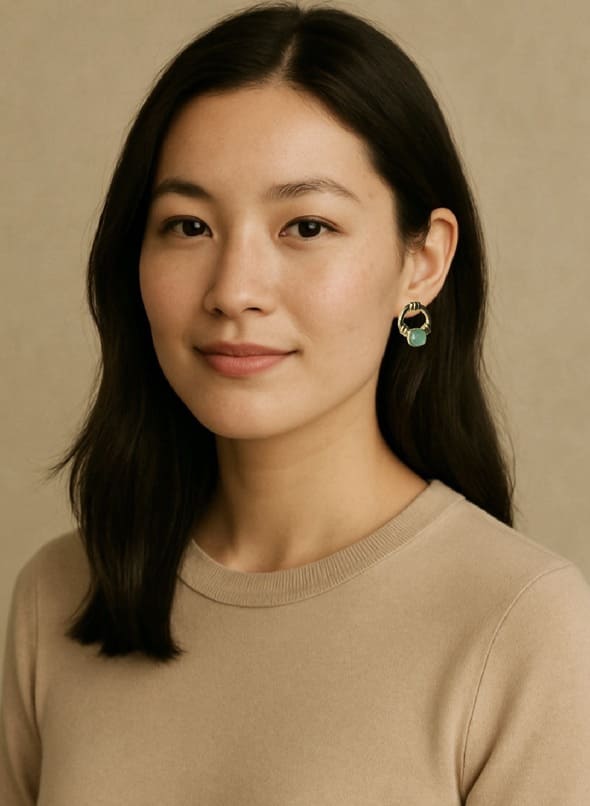 Woman in beige shirt wearing a beige shirt wearing artisanal sustainable gold-plated aqua chalking doorknocker earring with a beige background