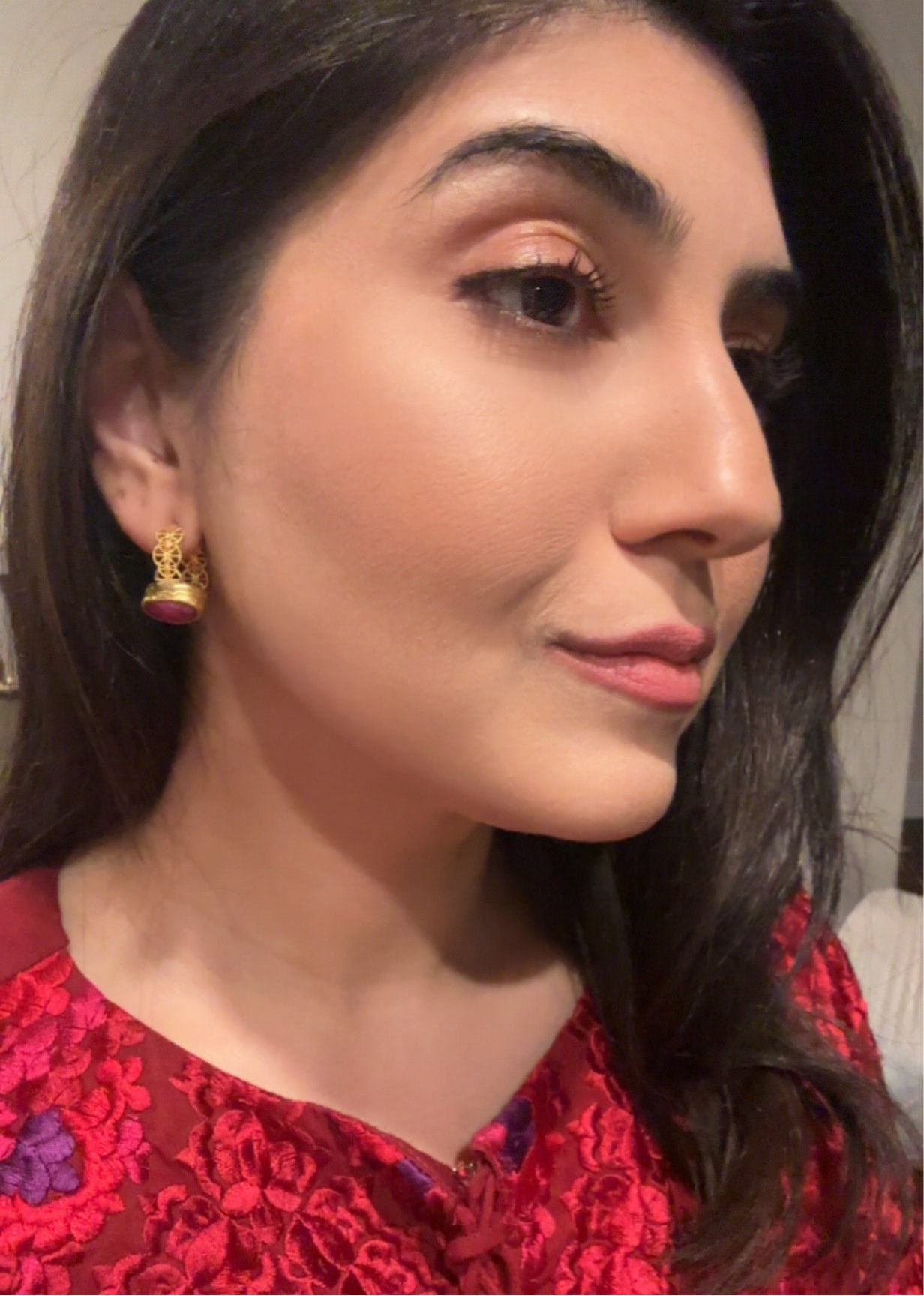 Woman wearing artisanal sustianable gokd-plated high quality lace ruby hoop earrings 