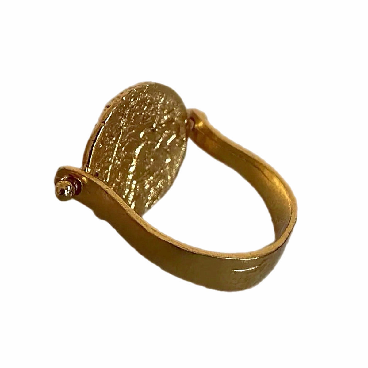 gold signet coin flip ring with a textured oval face and a small round accent