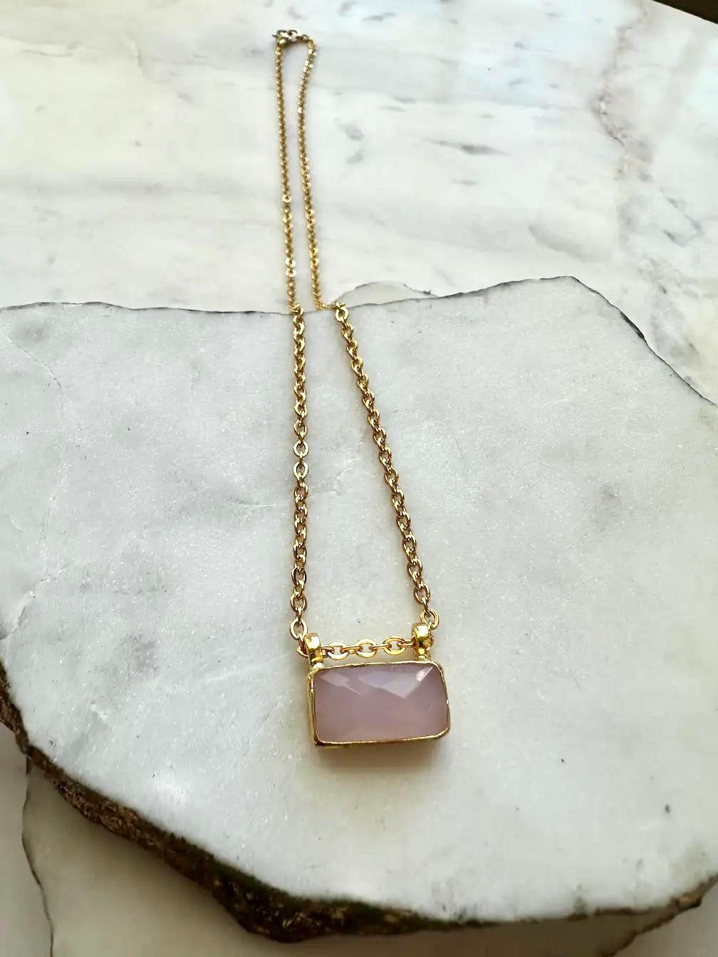 Handcrafted 21K gold-plated pink rose quartz gemstone pendant necklace on a marble surface