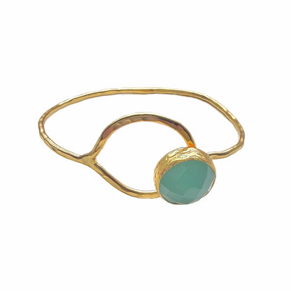 Artisanal gold-plated bracelet with round aqua chalcedony gemstone placed on white backdrop