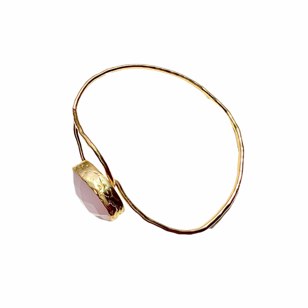 Handmade Gold bracelet with a pink gemstone on a white background-facing-left-side