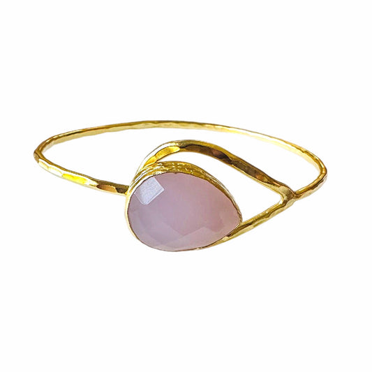 Handmade Gold bracelet with a pink gemstone on a white background