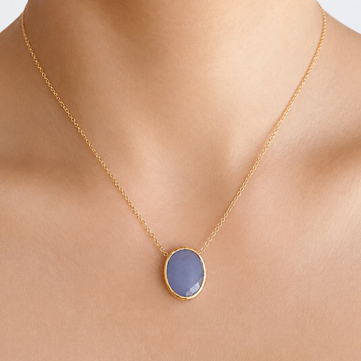 minimal gold chain faceted blue quartz pendant necklace on models neck