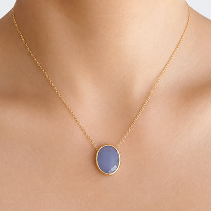minimal gold chain faceted blue quartz pendant necklace on models neck