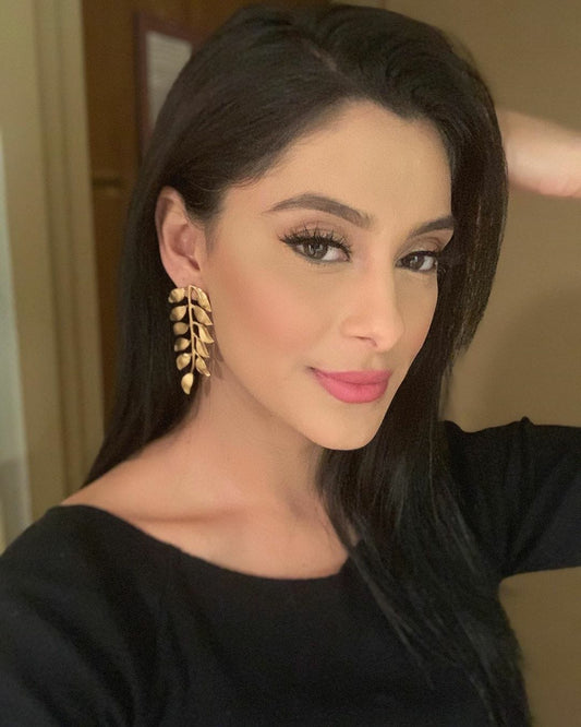 manpreet Toor wearing black shirt and handmade gold-plated vine earrings by Bebek Jewels 